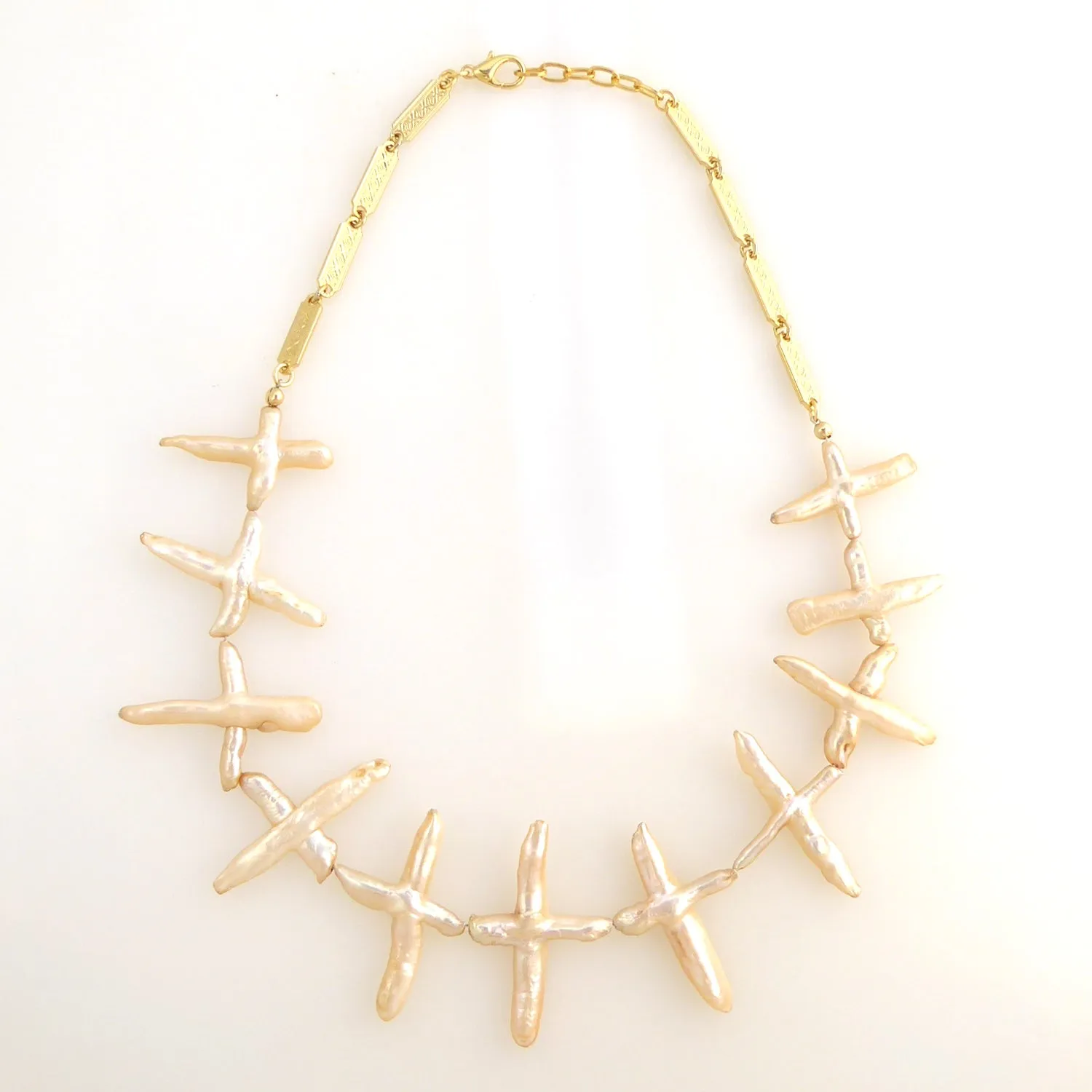 Pale peach pearl cross necklace