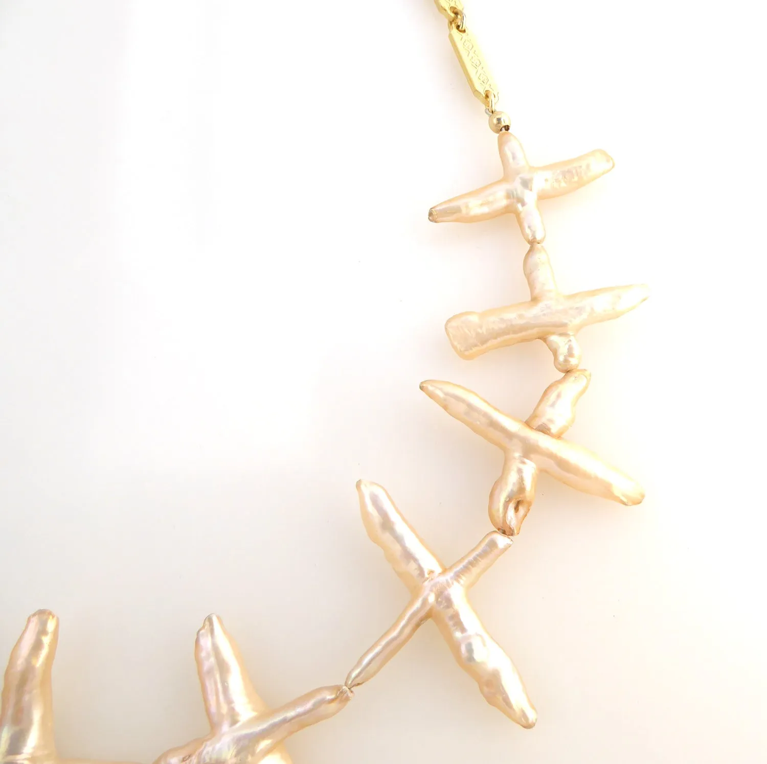 Pale peach pearl cross necklace