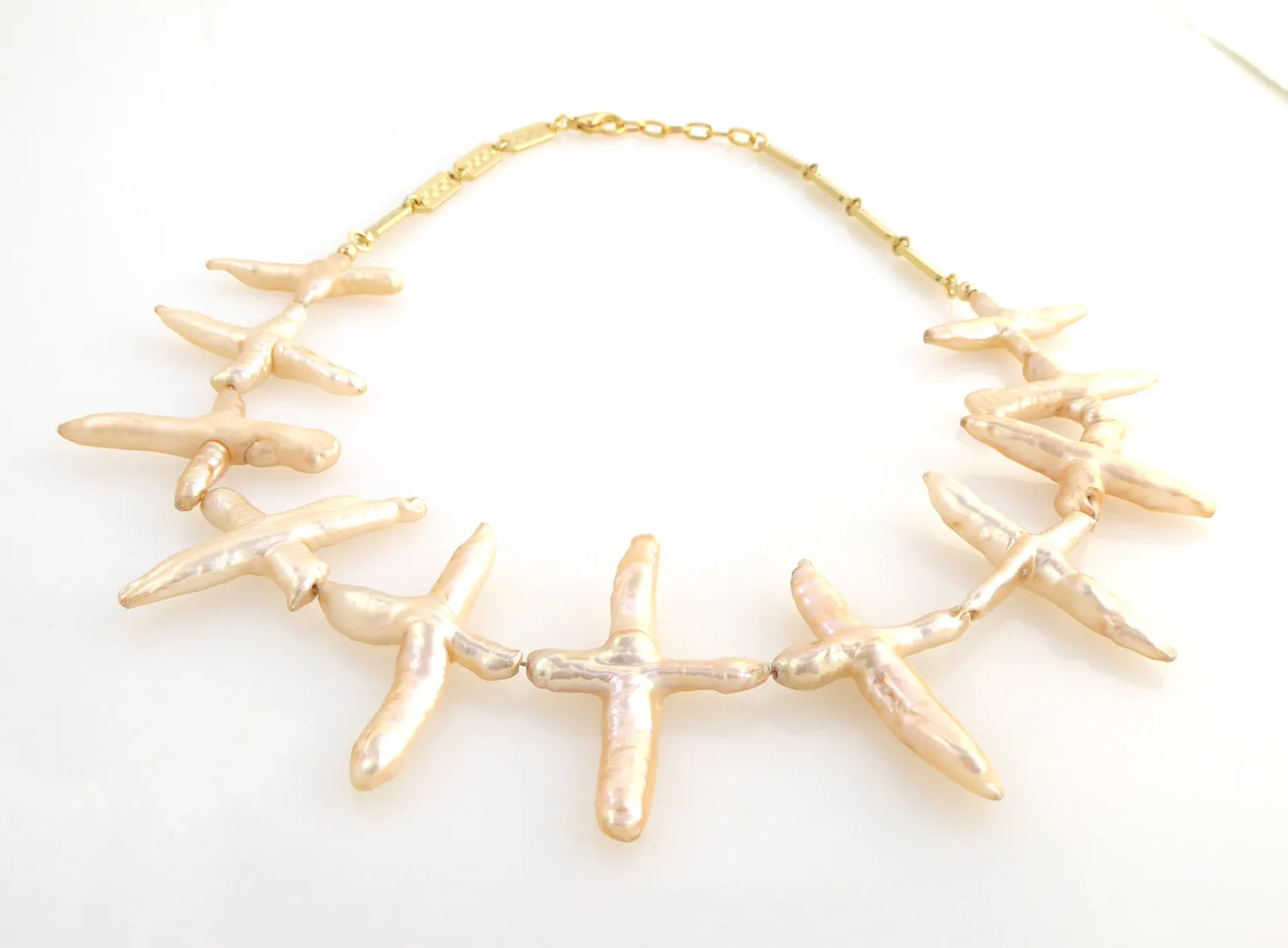 Pale peach pearl cross necklace
