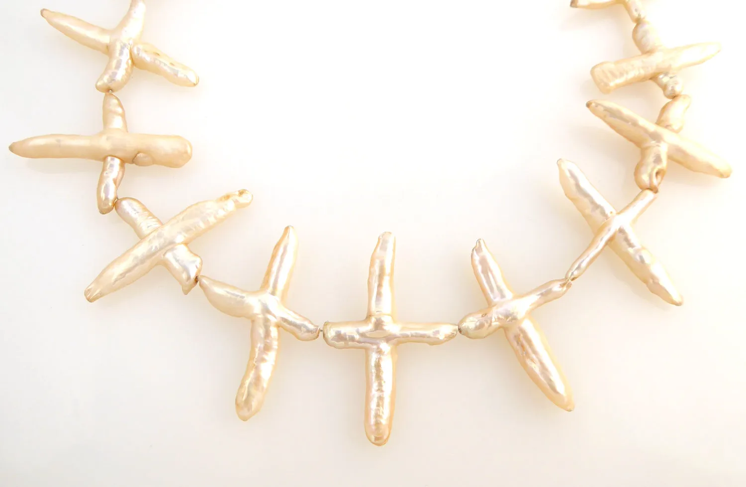 Pale peach pearl cross necklace