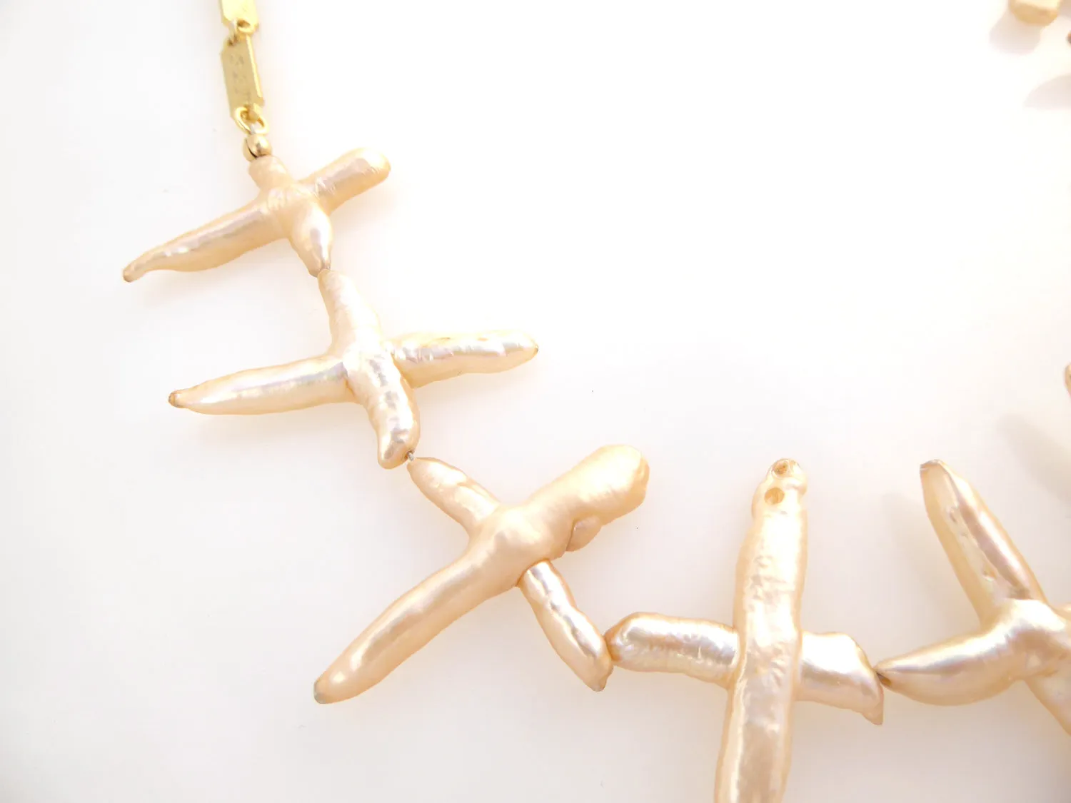 Pale peach pearl cross necklace